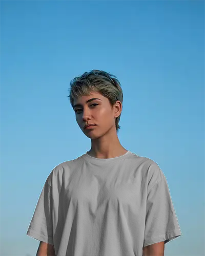 Dusk Sky Tshirt Mockup Female Model Gazing Forward In Evening Light With Clear Blue Backdrop