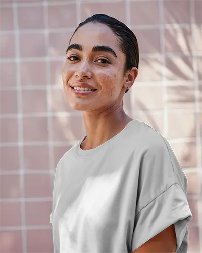 Tshirt Mockup Sunlit Tilewall Female Model Smiling In Soft Natural Light Urban Outdoor Vibe