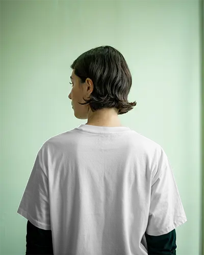 Tshirt Mockup Minimalist Green Background Female Model Facing Away In Soft Indoor Light Calm Mood