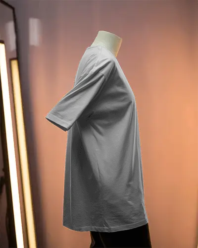 Side Profile Tshirt Mockup On Headless Mannequin Against Soft Pink Orange Gradient Backdrop And Studio Light