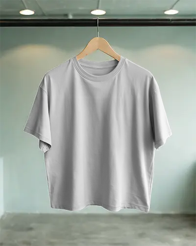Industrial Styled Tshirt Mockup Hanging On Wooden Hanger With Soft Ceiling Lighting And Muted Concrete Floor Background