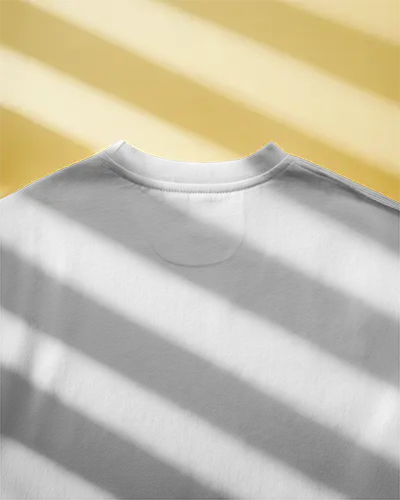 Sunlit Flatlay Tshirt Mockup White Shirt On Yellow Surface With Soft Shadow Clean And Minimal Style