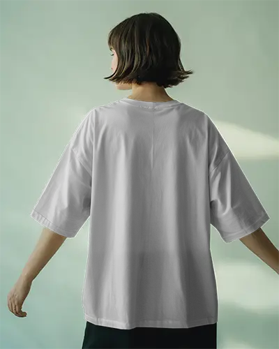 Studio Tshirt Mockup Woman Facing Away In Oversized Tee Soft Green Gradient Backdrop Flowy Pose