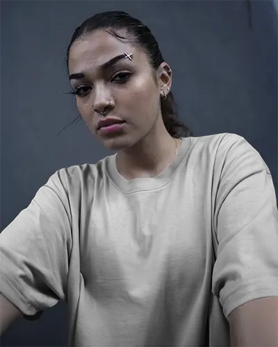 Urban Tshirt Mockup Woman In White Tee With Piercings Dark Blue Wall Edgy Streetwear Style