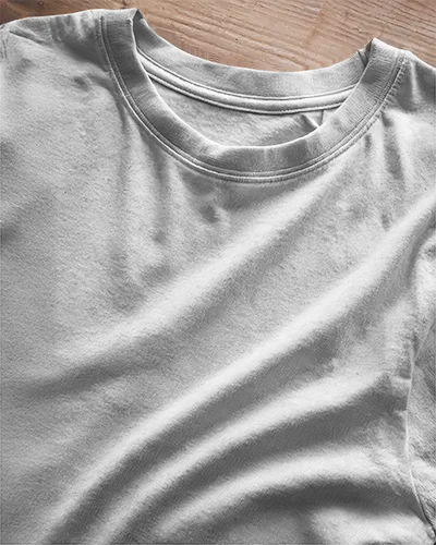 Closeup Tshirt Mockup White Tee With Design Laying On Wooden Surface Natural Light Folded Texture