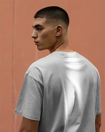 Outdoor Backview Tshirt Mockup Man In White Tee Facing Left Warm Peach Wall Soft Natural Light