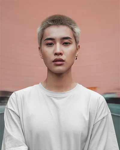 Urban Tshirt Mockup In White Tee Blonde Buzzcut Soft Pink Arched Wall Background Confident Look