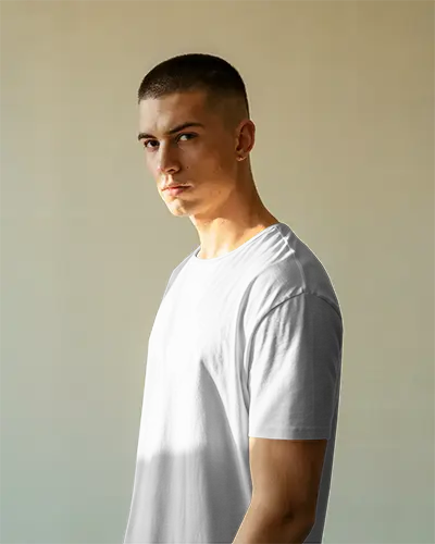 Sunlit Interior T Shirt Mockup Male Model Looking Ahead Soft Natural Light Background Casual Fit