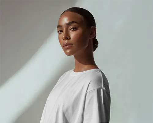 Sunbeam Lit T Shirt Mockup Female Model Facing Forward Minimal Aesthetic Shadow Elegant Studio