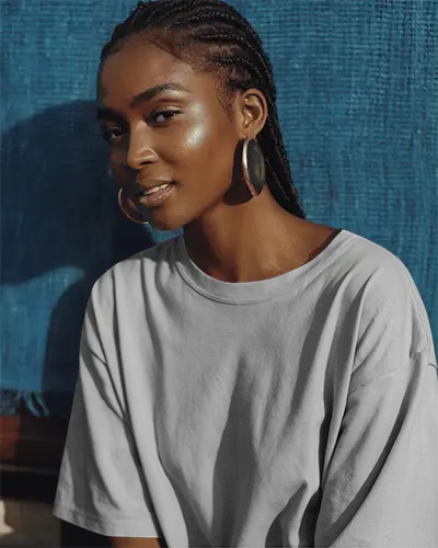 Outdoor Lifestyle Tshirt Mockup Sunlit Scene Featuring Female Model In Relaxed Pose And Blue Backdrop