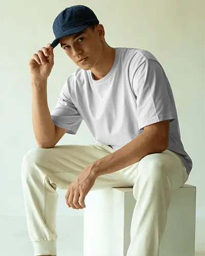 Relaxed Fit Tshirt Mockup Young Man In Cap And Light Pants Modern Neutral Background Bright Interior