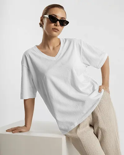 Fashion Forward V Neck T Shirt Mockup Female Model In Sunglasses And Pleated Pants On White Studio Backdrop