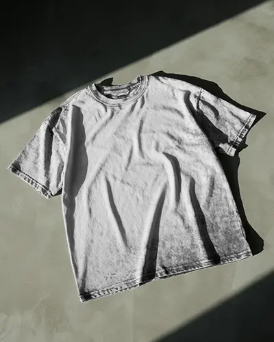 High Contrast Acid Wash T Shirt Mockup Moody Light Play On Raw Industrial Floor Background