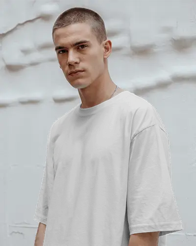 Urban Streetwear T Shirt Mockup Male Model Standing Against Textured White Wall Background