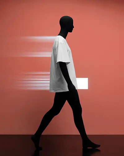 Motion Themed Fashion T Shirt Mockup Black Mannequin Walking Past Vibrant Orange Wall