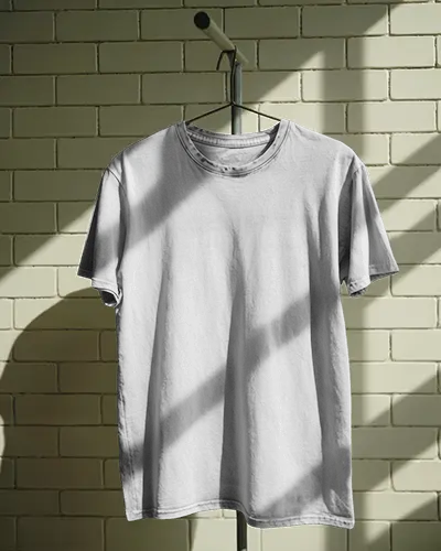 Sunlit Wall Hanger Washed Tshirt Mockup Tee On Metal Stand Casting Shadows On Soft Brick Wall