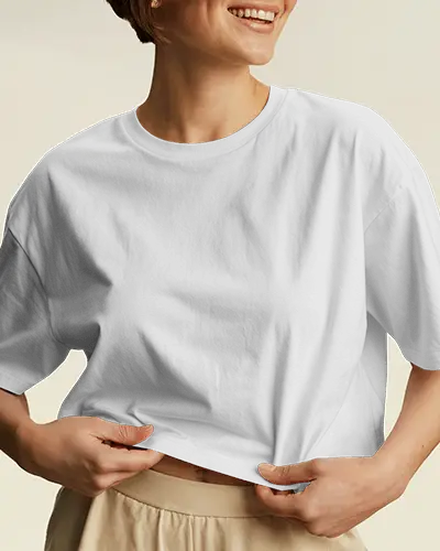 Cropped Studio T Shirt Mockup Woman Smiling And Holding T Shirt In Bright Neutral Light