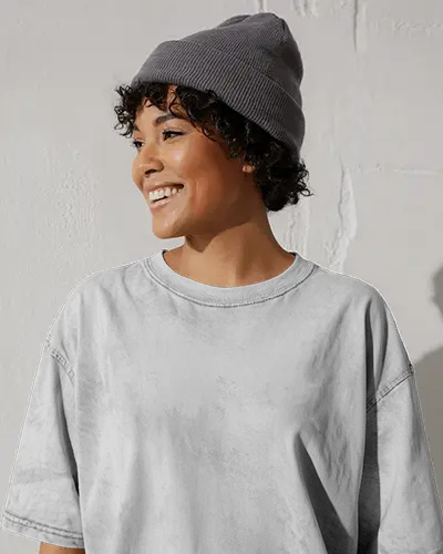 Outdoor Acid Wash T Shirt Mockup Curly Haired Model Smiling In Soft Sunlight Near White Wall