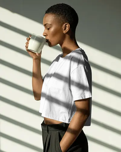 Moody Shadow T Shirt Mockup Side View Model Drinking Coffee In Striped Light Interior