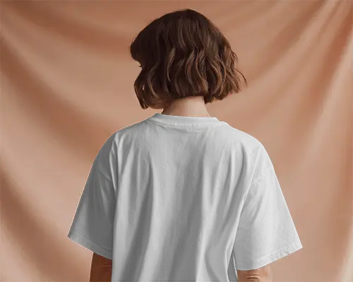 Rear Tshirt Mockup Female Model With Bob Cut In Soft Peach Curtain Studio Background 02042