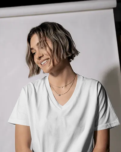 Studio Vneck T Shirt Mockup Smiling Model In Layered Necklace And Curved Backdrop
