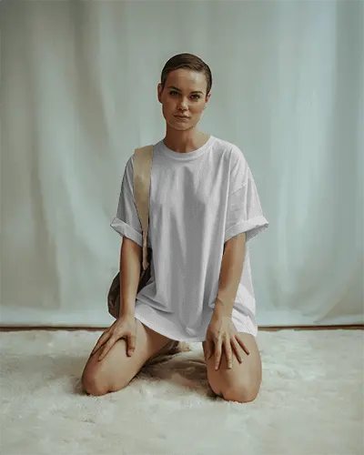 Studio Carpet Tshirt Mockup Woman Kneeling On Rug In Oversized Shirt Minimal Backdrop Soft Lighting