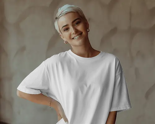 Smiling Female Model Wearing Relaxed T Shirt Mockup With Short Hair And Soft Background Light
