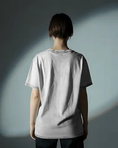 Back View Washed T Shirt Mockup On Model Soft Spotlight Shadowed Studio Setting