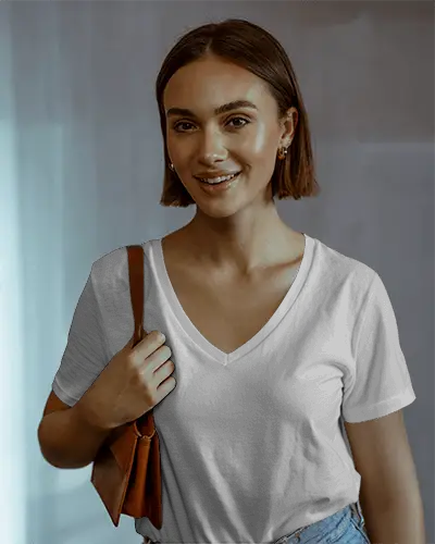 Casual V Neck T Shirt Mockup Female Model Smiling In Soft Light With Leather Shoulder Bag