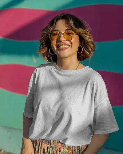 urban-vibes-t-shirt-mockup-smiling-female-model-in-streetwear-against-wavy-mural