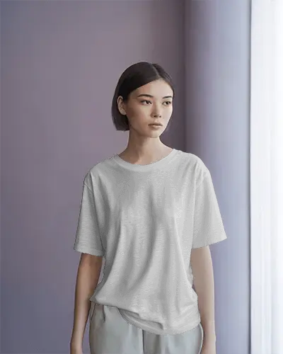 Casual T Shirt Mockup With Woman Standing In Serene Room Under Natural Morning Window Light