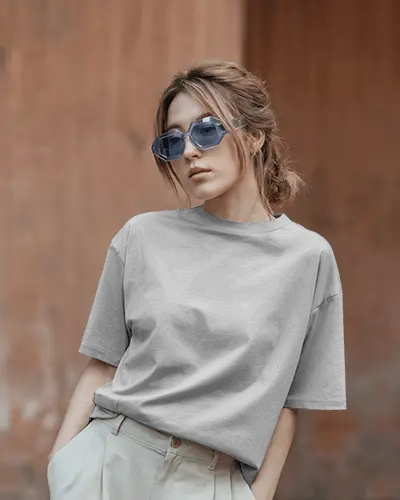 Urban Female T Shirt Mockup Blue Sunglasses Model With Beige Trousers And Brick Backdrop