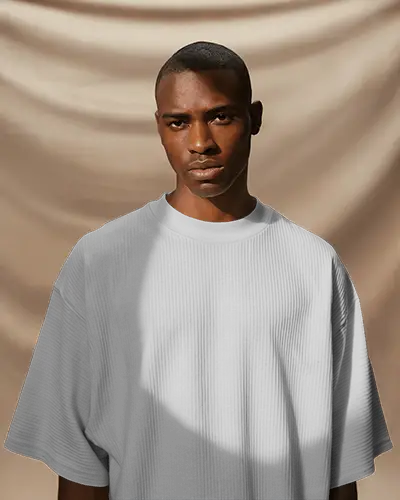 Studio Light Tshirt Mockup Black Male Model Serious Look Warm Beige Draped Background