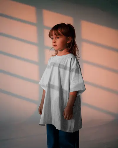 Kids T Shirt Mockup Girl Standing In Soft Sunset Window Light With Calm And Serene Expression