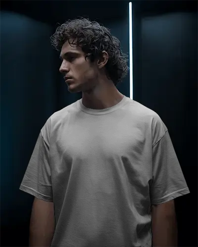 cinematic-low-light-t-shirt-mockup-male-model-with-curly-hair-in-studio-setting