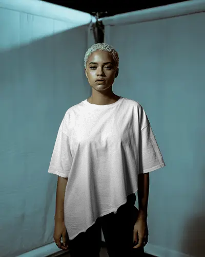 moody-studio-t-shirt-mockup-female-model-front-facing-in-soft-blue-toned-lighting