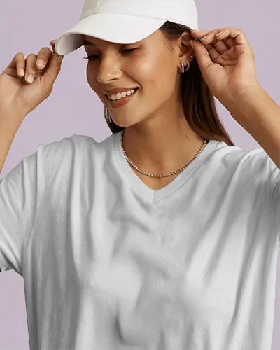 casual-v-neck-t-shirt-mockup-smiling-female-model-adjusting-cap-in-soft-lighting