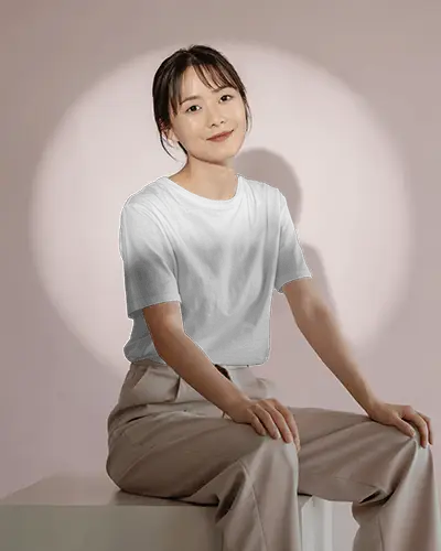 casual-seated-female-model-tshirt-mockup-soft-pink-background-with-spotlight-studio-lighting