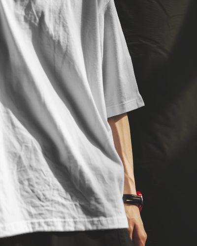 Asian Man Wearing Tshirt Mockup With Red Curtain Flying In Background Scene4