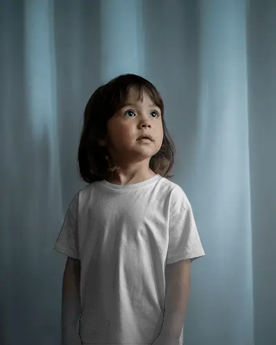 kids-tshirt-mockup-on-child-model-standing-in-soft-light-with-curtain-and-natural-shadows