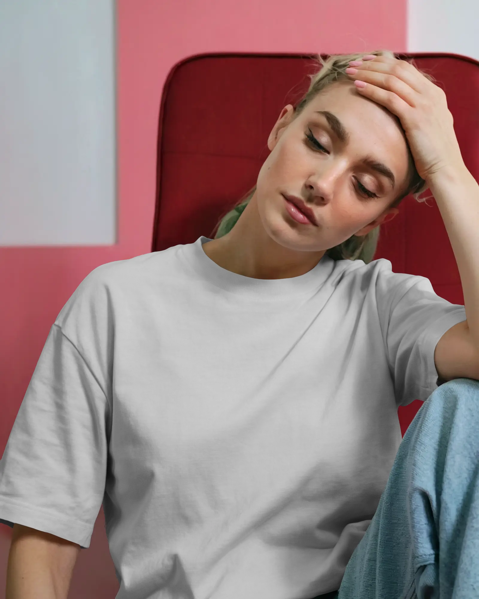 Resting Head T Shirt Mockup Female Model Pink Backdrop Soft Lighting Relaxed Studio Shot