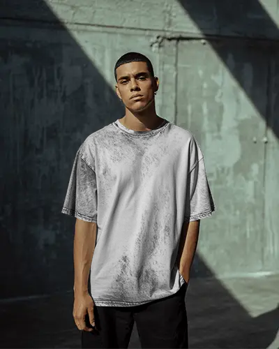 Urban Streetwear Tshirt Mockup On Male Model In Industrial Setting With Sharp Light And Shadow
