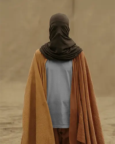 Desert Themed Tshirt Mockup Masked Model Wrapped In Earth Toned Cloak With Dusty Sand Backdrop