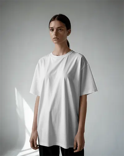 Minimalist Studio T Shirt Mockup Female Model Standing In Soft Daylight Clean And Modern Style