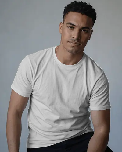 Relaxed T Shirt Mockup Male Model Sitting With Soft Smile Natural Studio Lighting Style