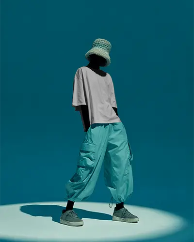 Spotlight Fashion Tshirt Mockup Black Model In Casual Style With Bucket Hat Teal Background Studio