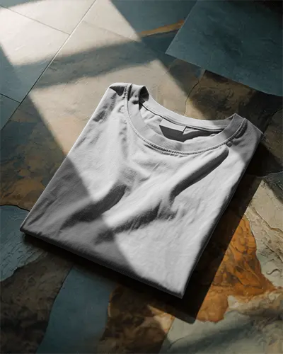 Folded Flatlay Tshirt Mockup On Stone Floor With Natural Sunlight And Shadow Cinematic Presentation