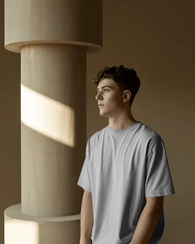Sunlit Architectural Tshirt Mockup Male Model Standing By Column Soft Golden Light Studio Vibe