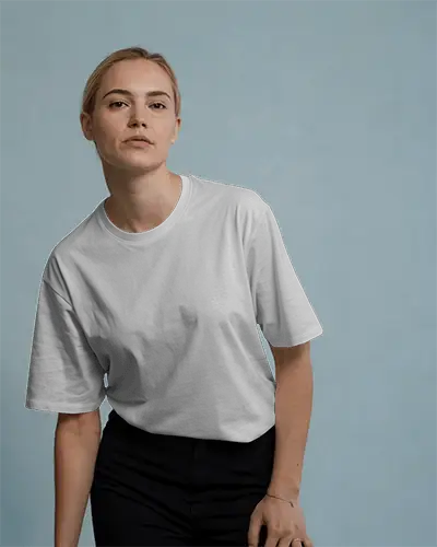 Minimalist Studio T Shirt Mockup Female Model In Relaxed Pose Against Soft Blue Backdrop