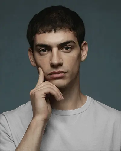 Thoughtful Pose T Shirt Mockup Hand On Face Studio Style Dark Backdrop Modern Minimalist